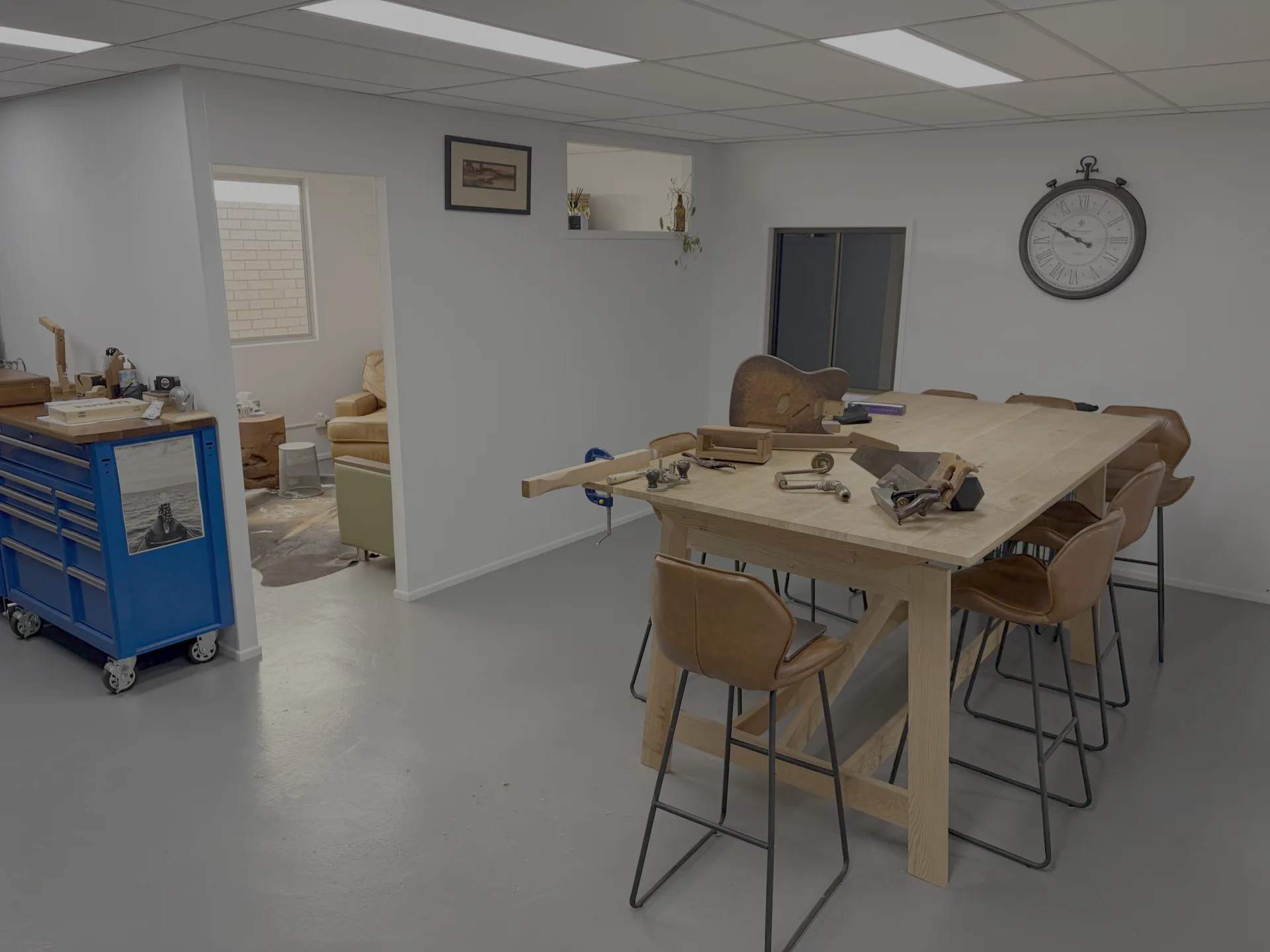 The Timber Therapy workshop with a timber workbench, hand tools, and a guitar in progress